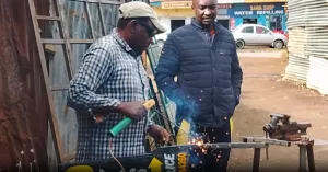 Two men engaged in a metalworking activity