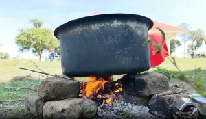 Outdoor cooking pot in use above a fire